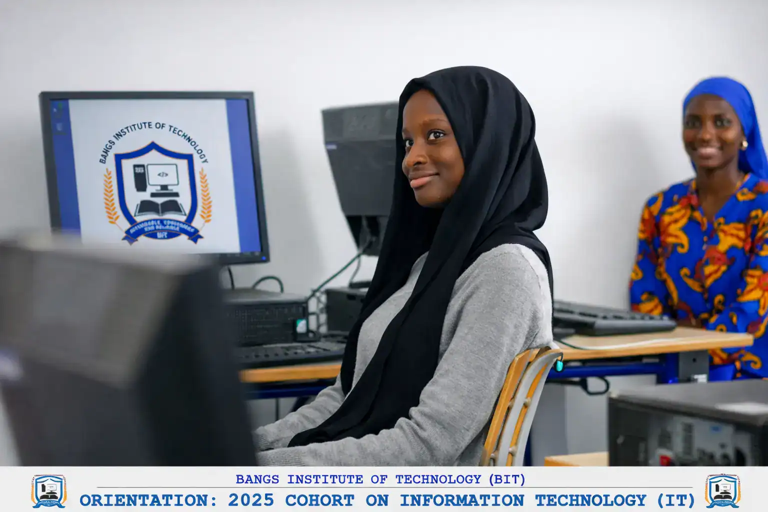 African female ICT student learning computer skills in a modern computer lab at Bangs Institute of Technology in The Gambia.